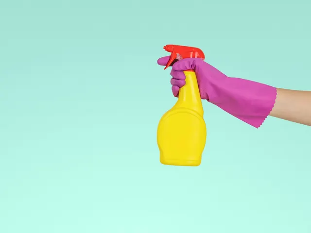 A cleaner holding a spray bottle