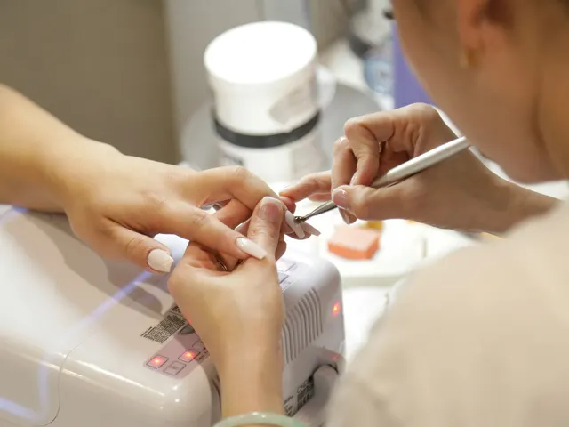A manicurist doing a client's nails at a nail salon